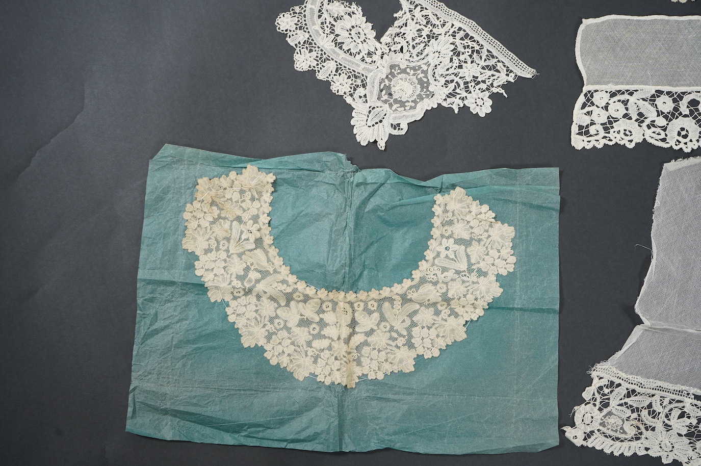 A late 19th century Brussels bobbin lace on net section of a wedding veil, Brussels bobbin lace collar, a point de gaz lace motif and two lengths of later bobbin lace trimming possibly Honiton with needle lace insertions